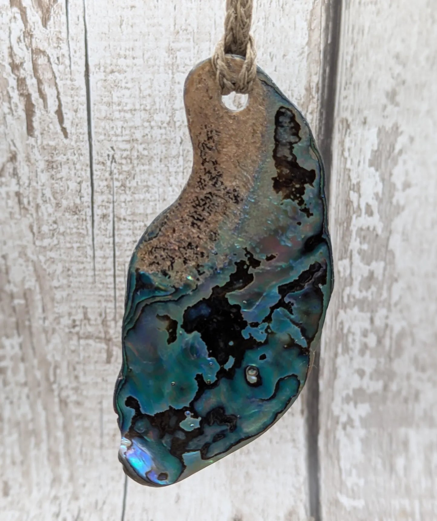 New Zealand free form naturally tumbled Pāua shell pendant.