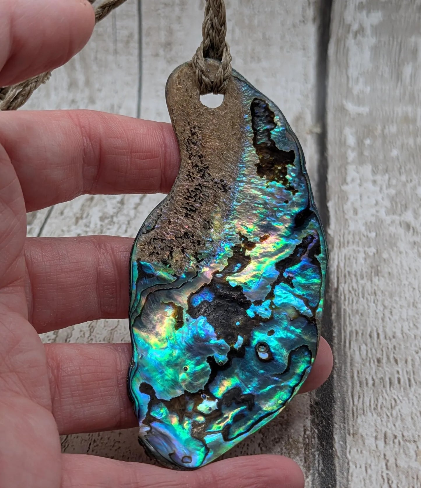 New Zealand free form naturally tumbled Pāua shell pendant.