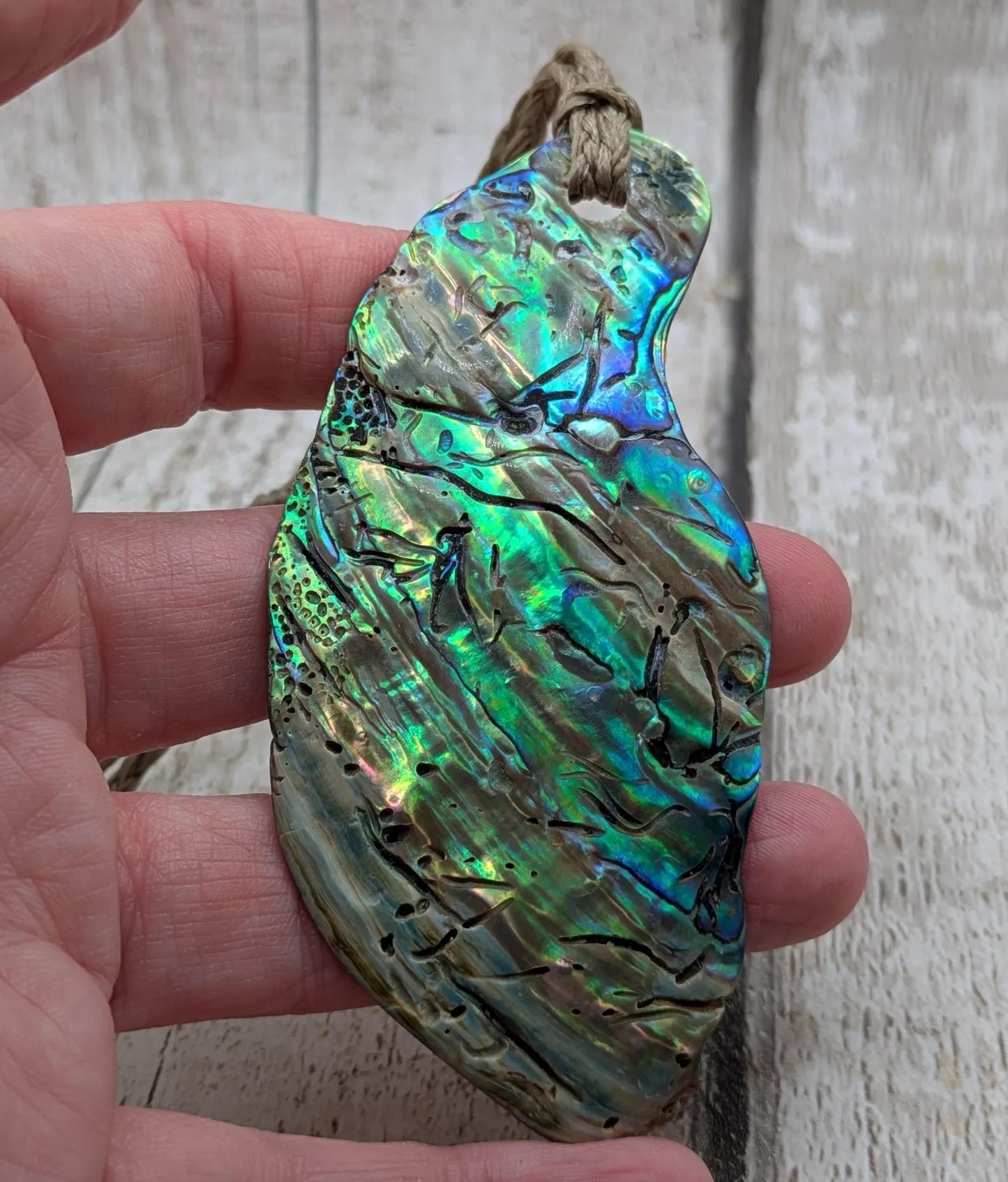 New Zealand free form naturally tumbled Pāua shell pendant.