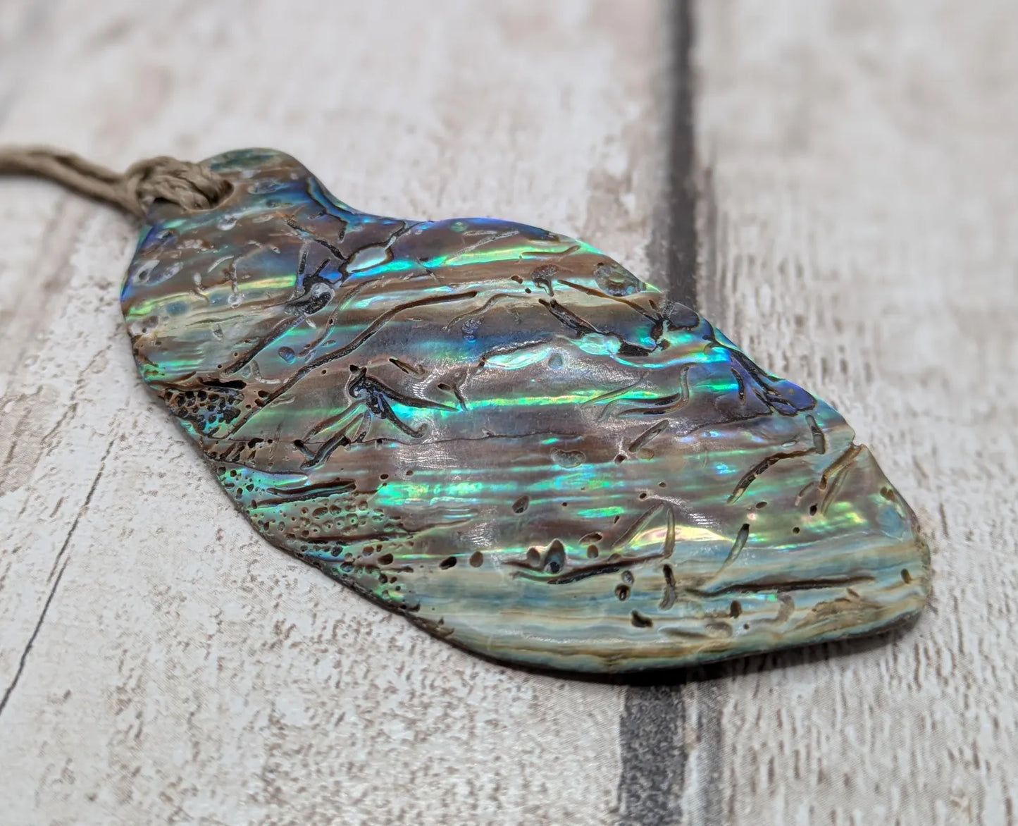 New Zealand free form naturally tumbled Pāua shell pendant.
