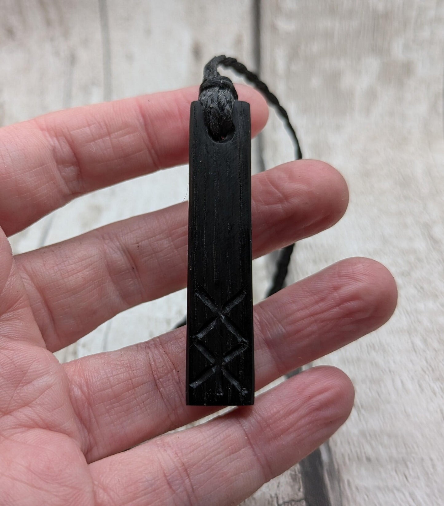 Fenland bog oak with protection bind rune pendant.