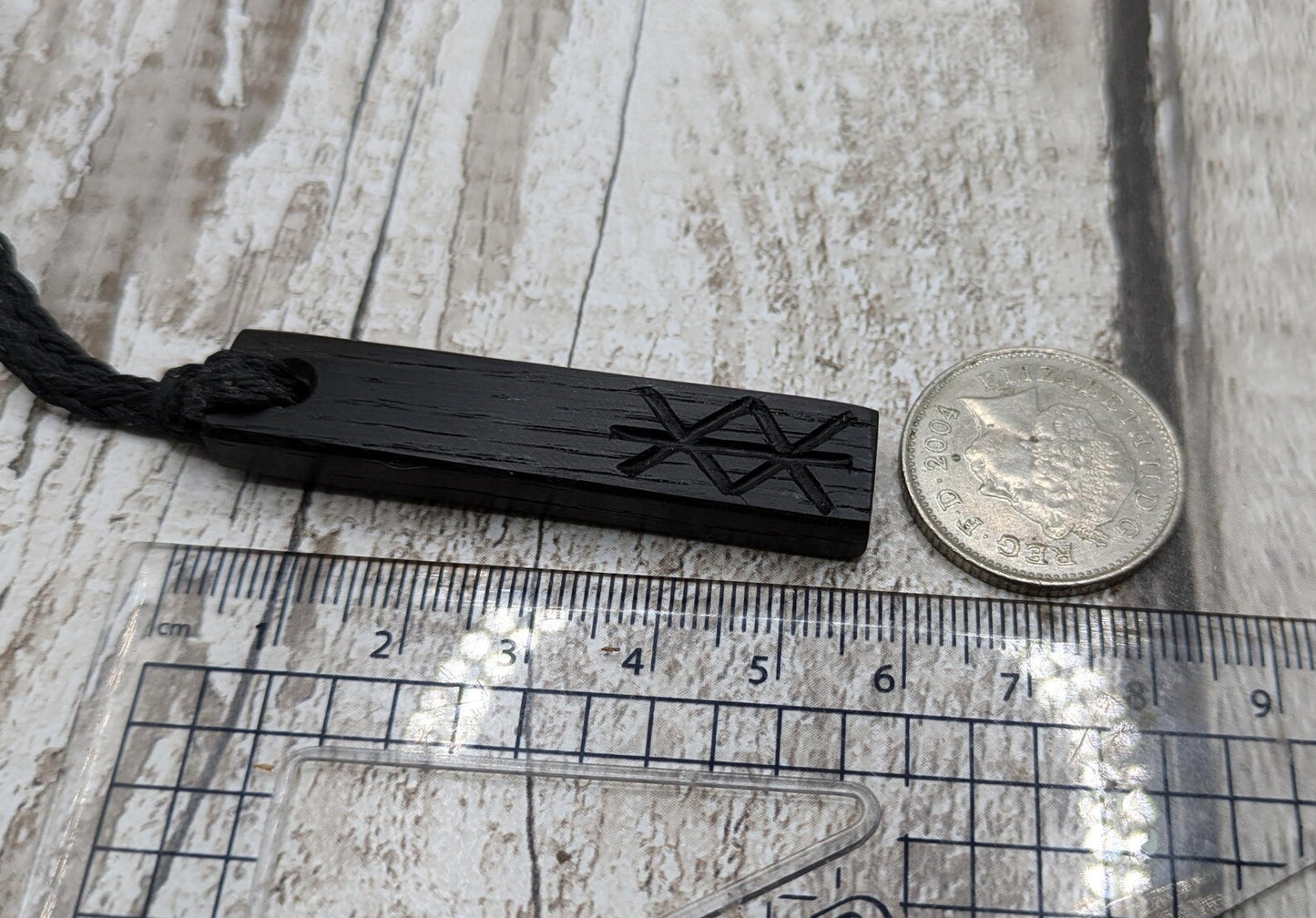 Fenland bog oak with protection bind rune pendant.