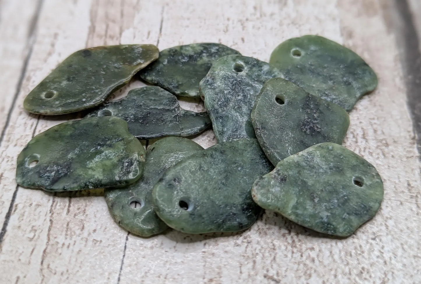 10 top drilled Pounamu greenstone jade beads.