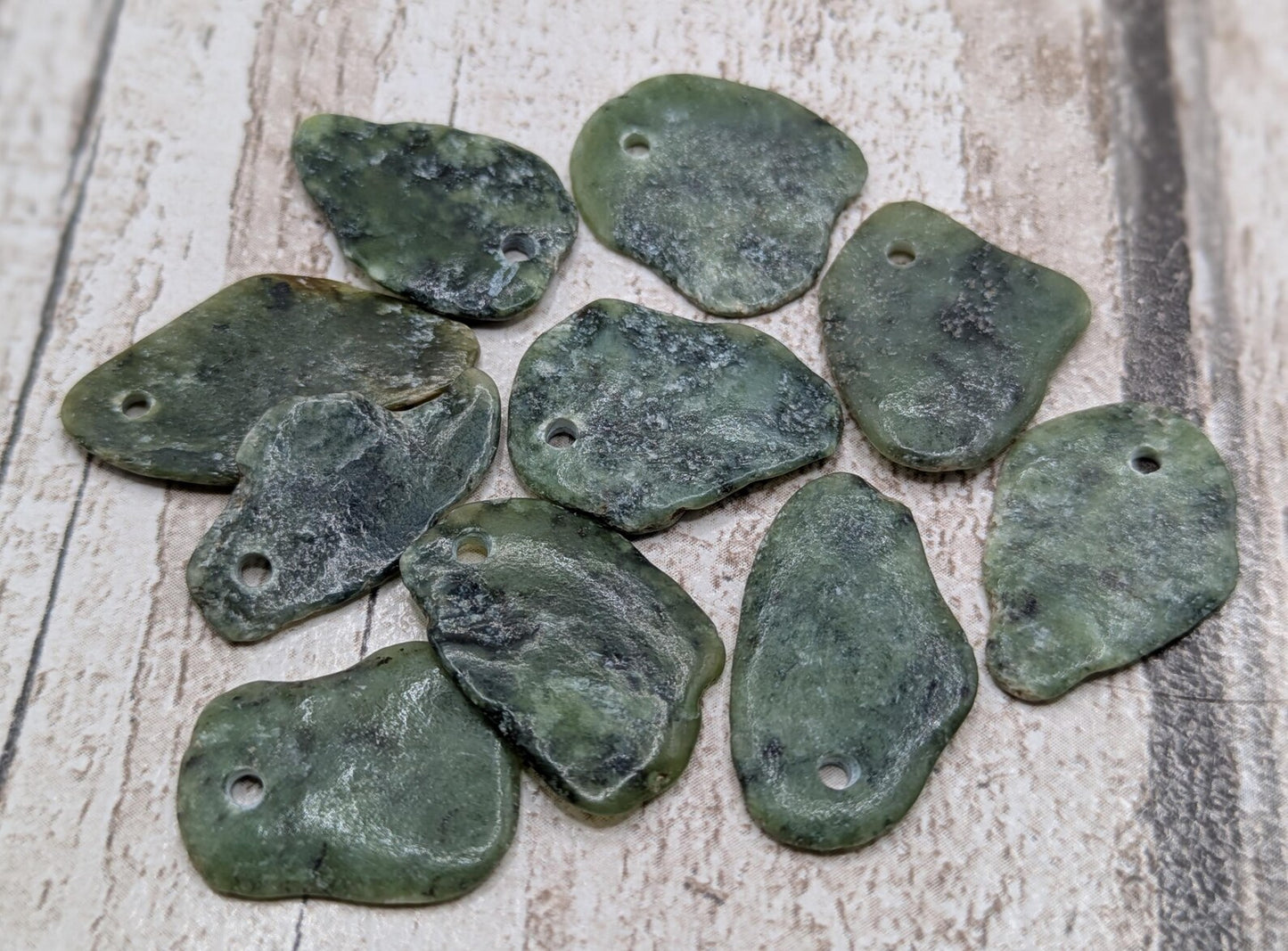 10 top drilled Pounamu greenstone jade beads.