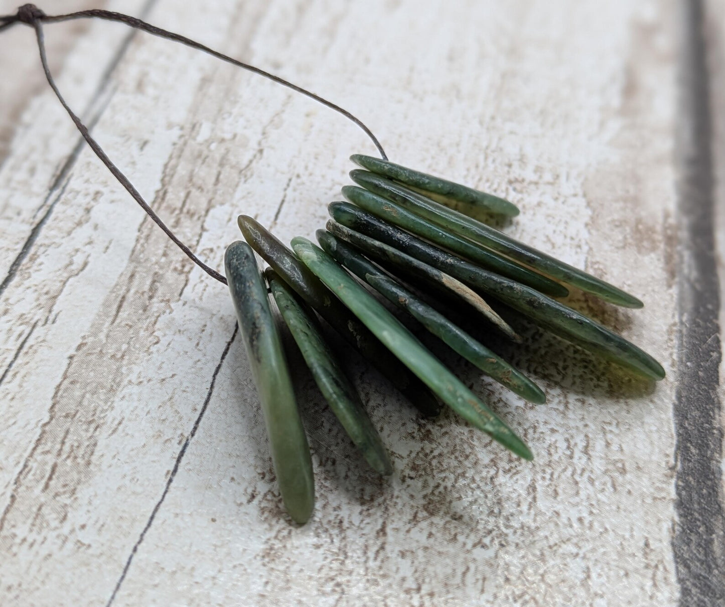 10 top drilled Pounamu greenstone jade beads.