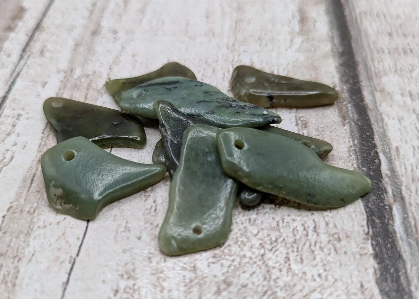 10 top drilled tumbled greenstone jade beads.