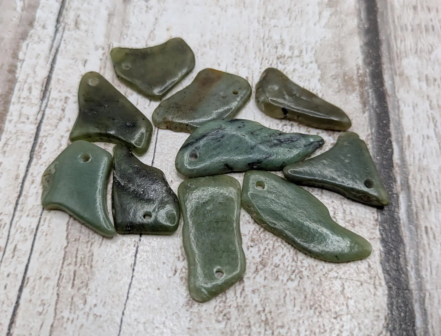 10 top drilled tumbled greenstone jade beads.
