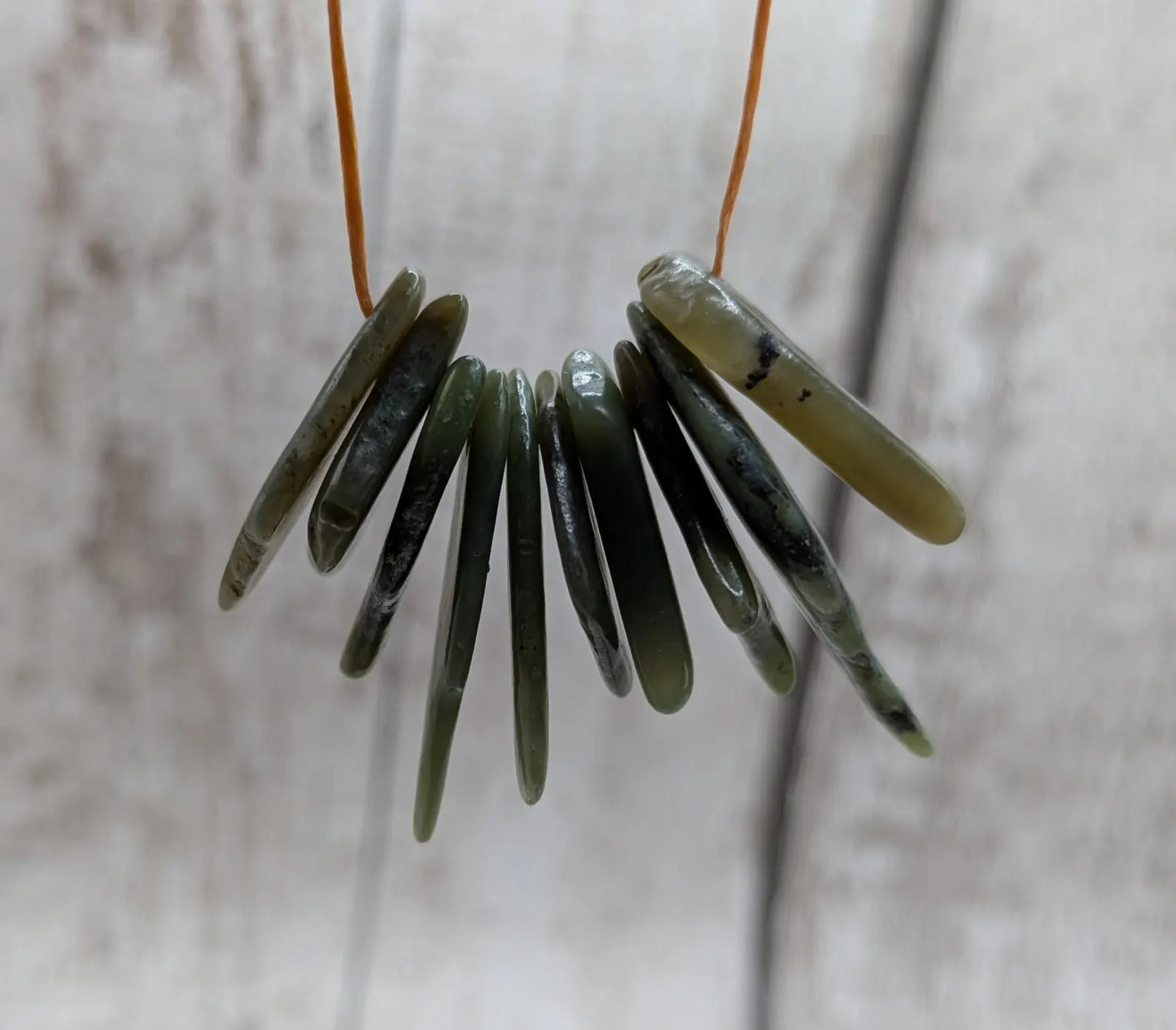 10 top drilled tumbled greenstone jade beads.