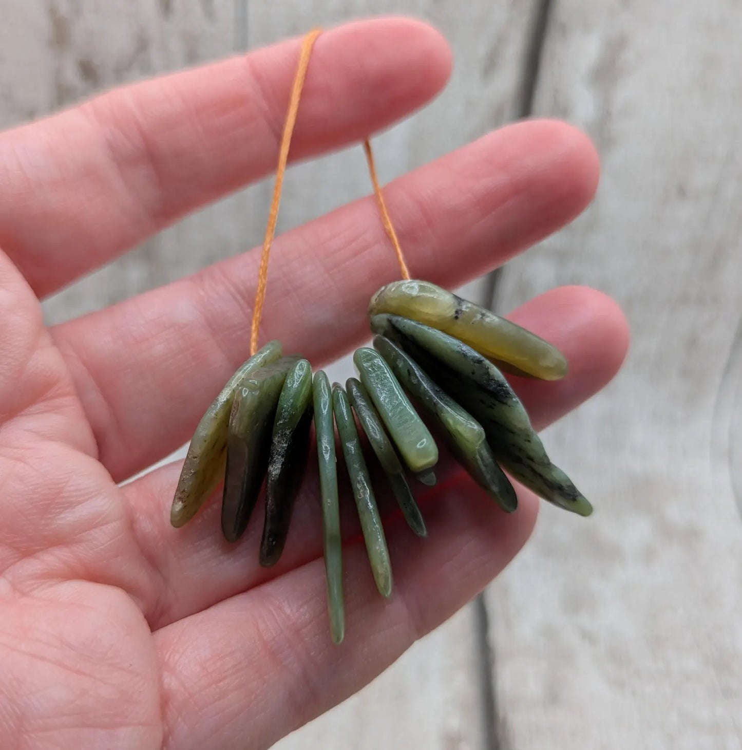10 top drilled tumbled greenstone jade beads.