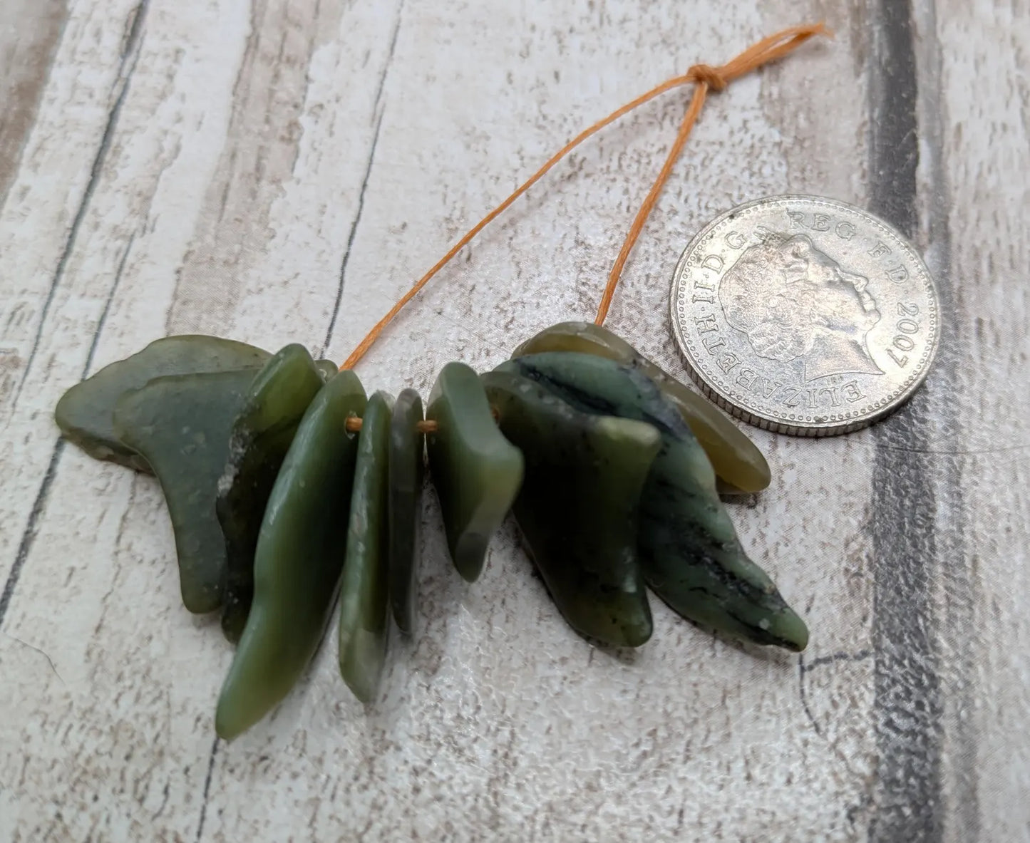 10 top drilled tumbled greenstone jade beads.
