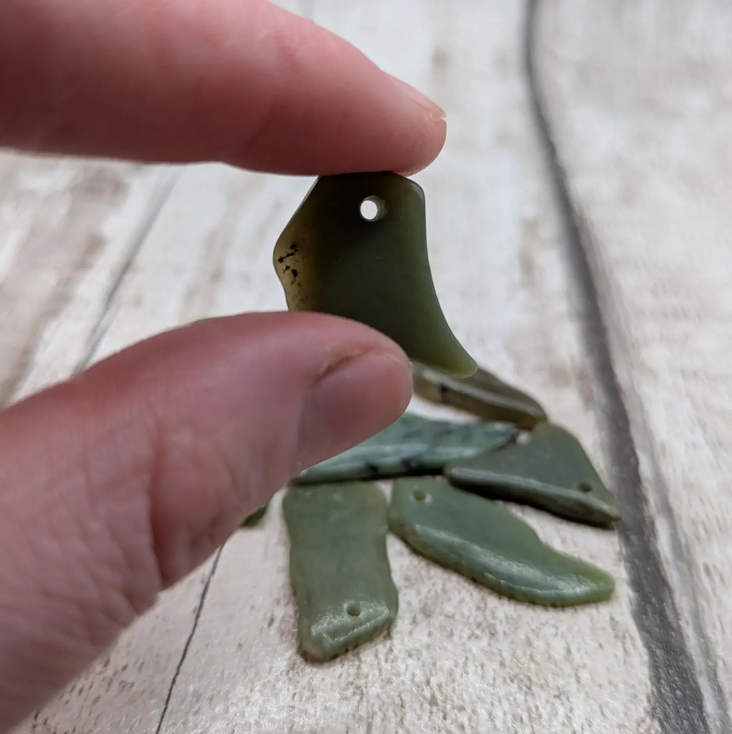10 top drilled tumbled greenstone jade beads.