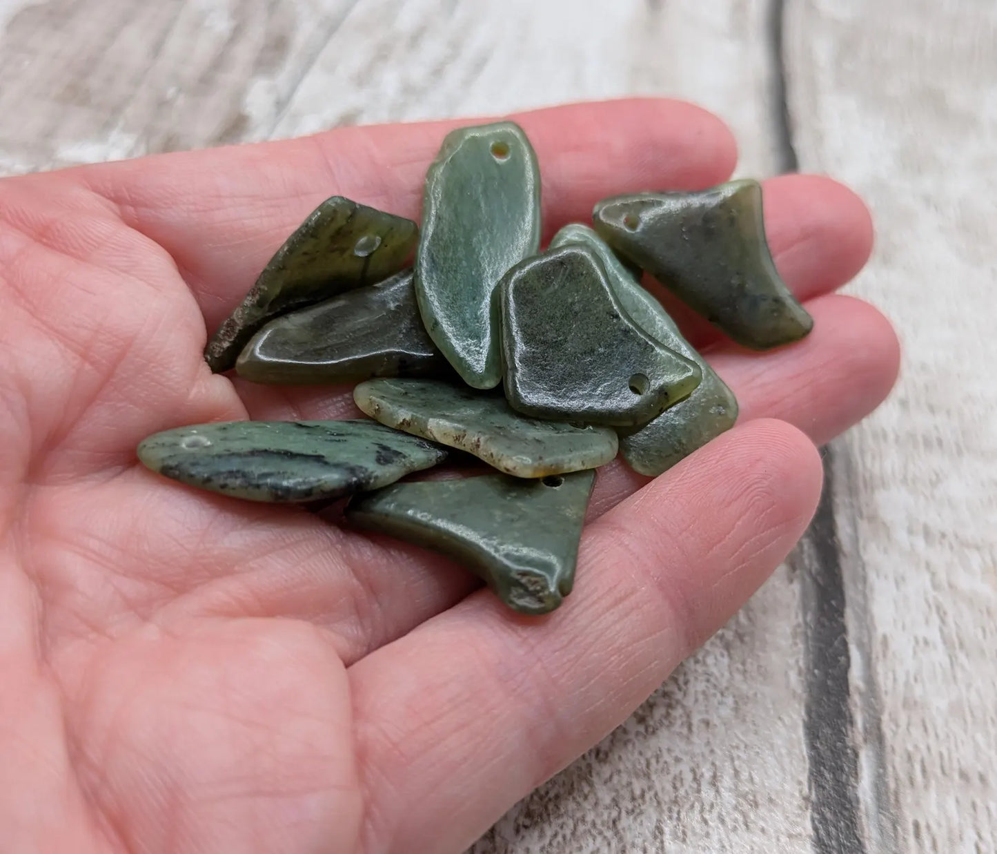 10 top drilled tumbled greenstone jade beads.