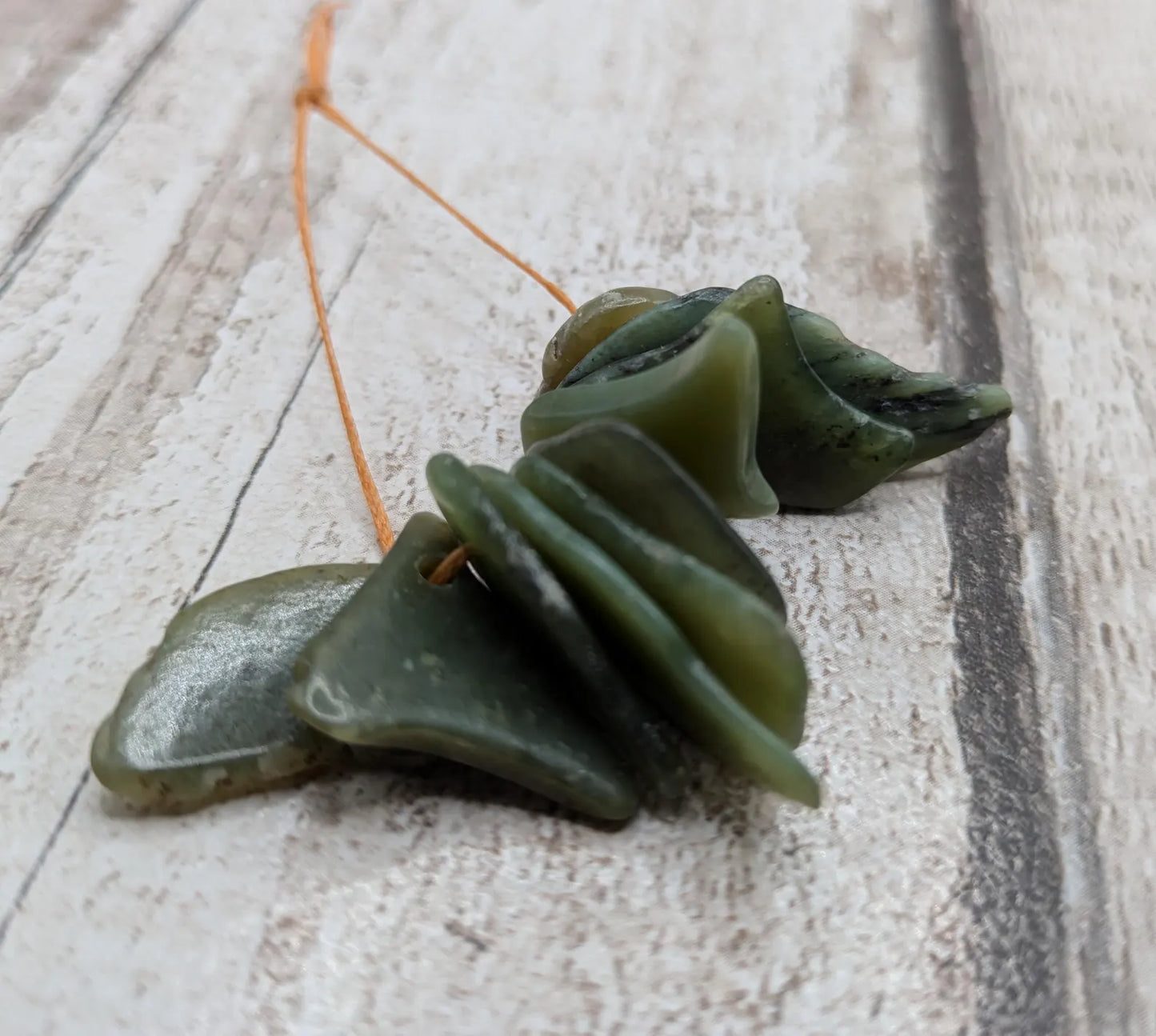 10 top drilled tumbled greenstone jade beads.