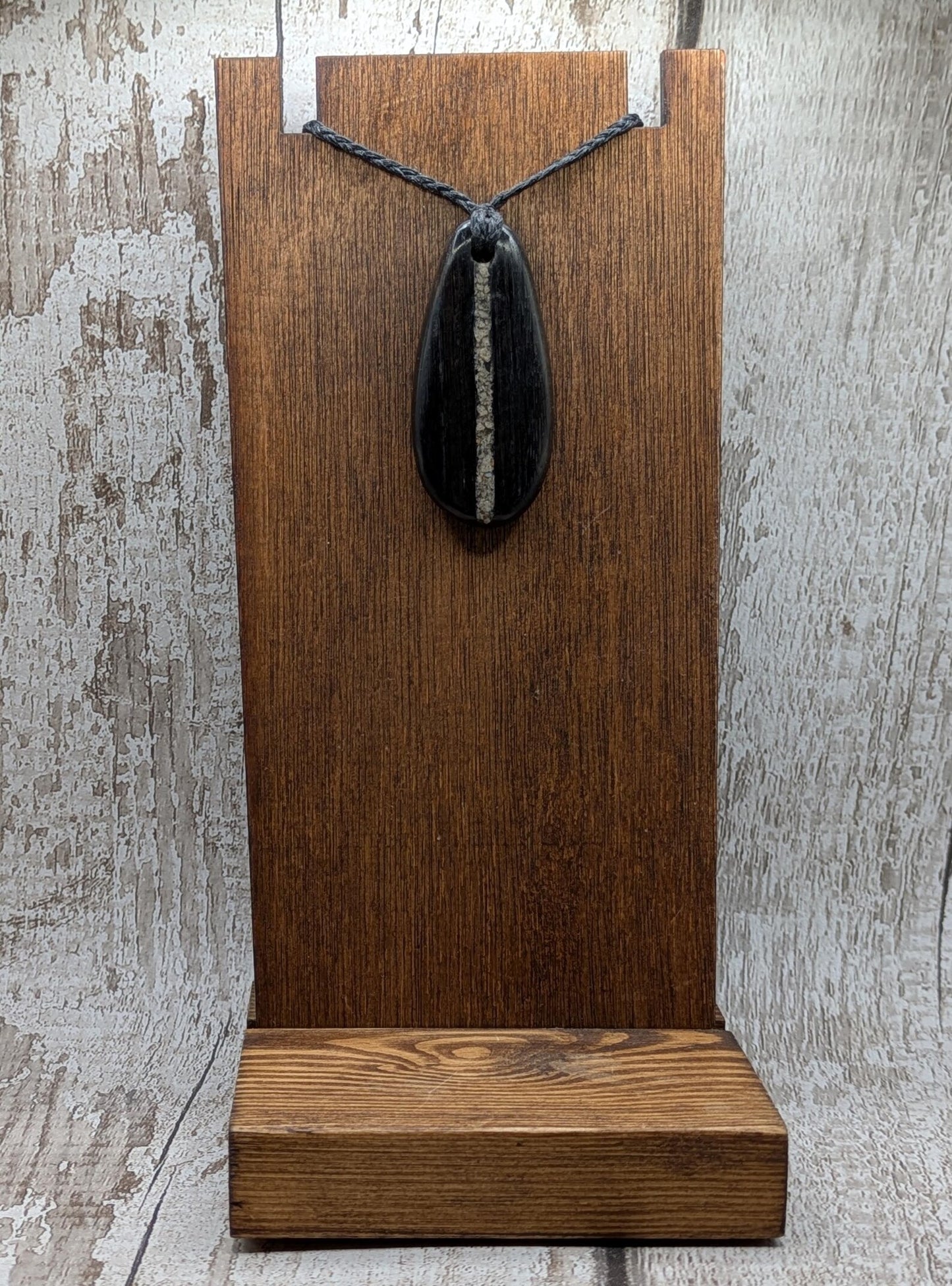 Fenland bog oak wood oval pendant with Avebury Sarsen central inlay.