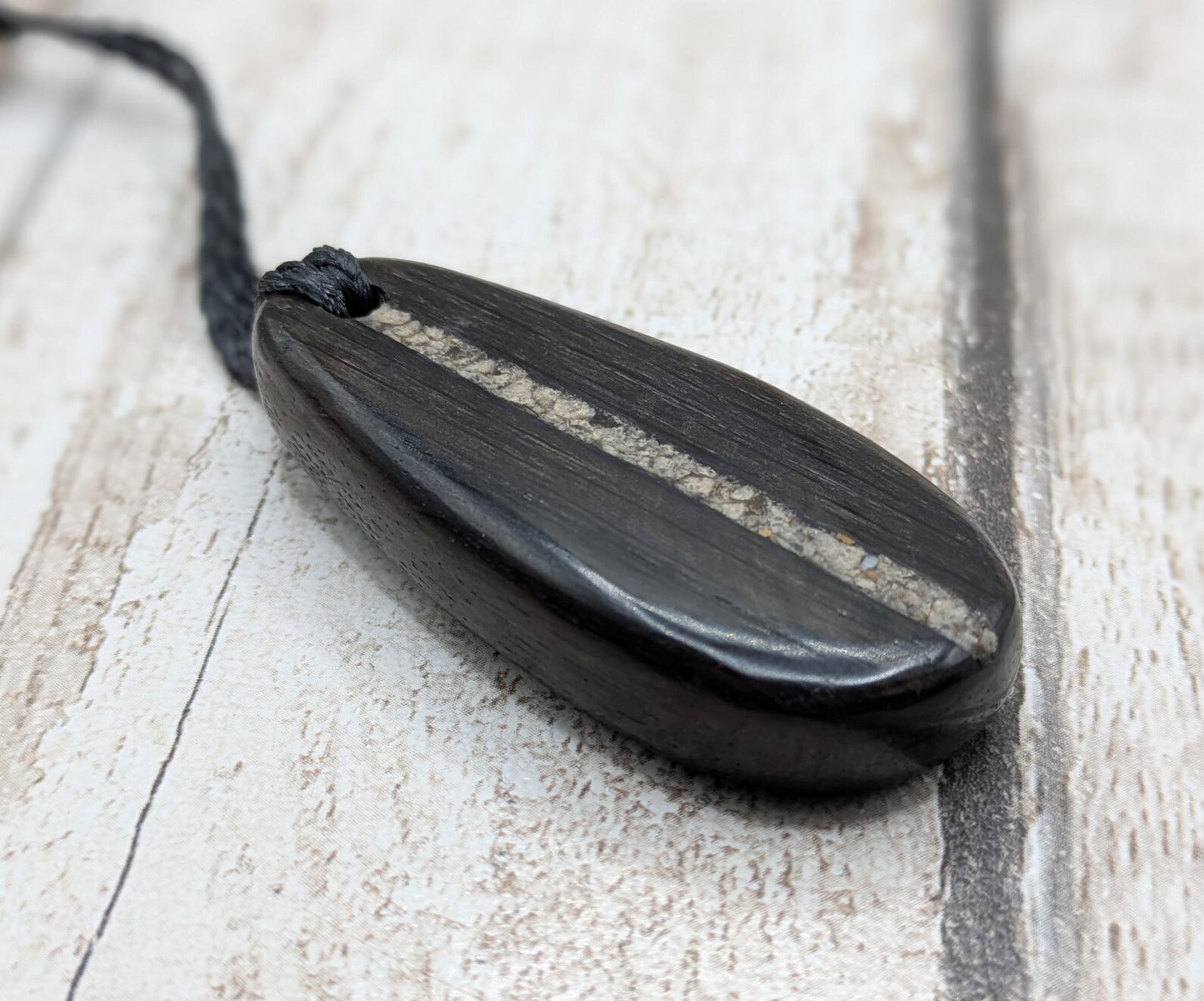 Fenland bog oak wood oval pendant with Avebury Sarsen central inlay.