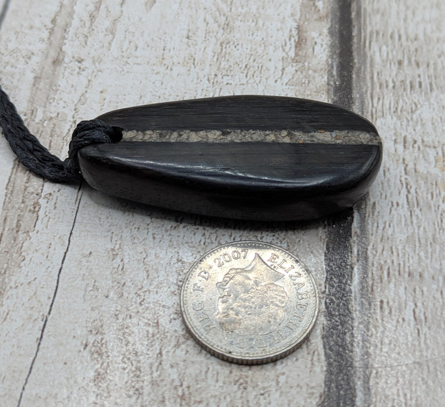 Fenland bog oak wood oval pendant with Avebury Sarsen central inlay.