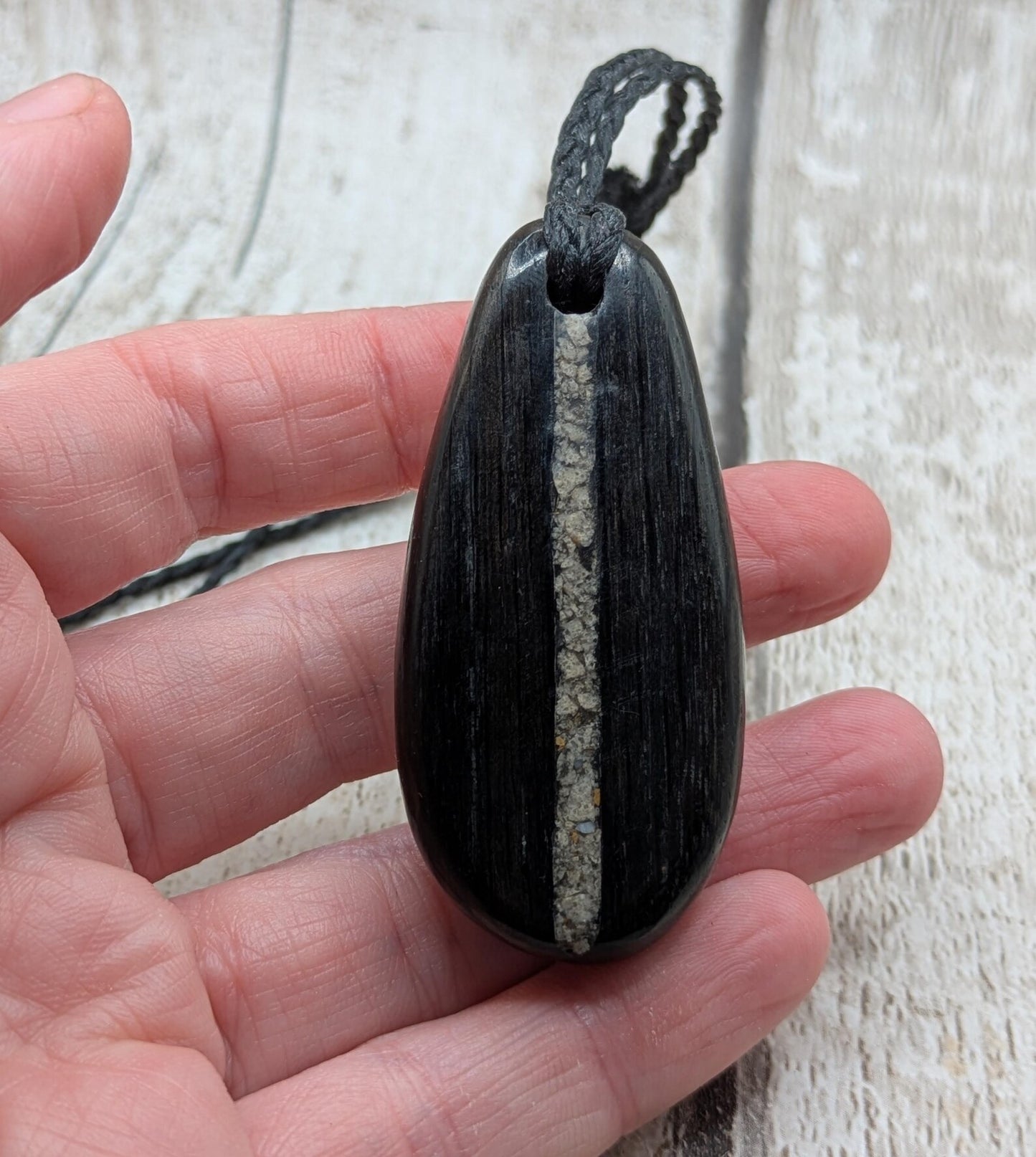 Fenland bog oak wood oval pendant with Avebury Sarsen central inlay.