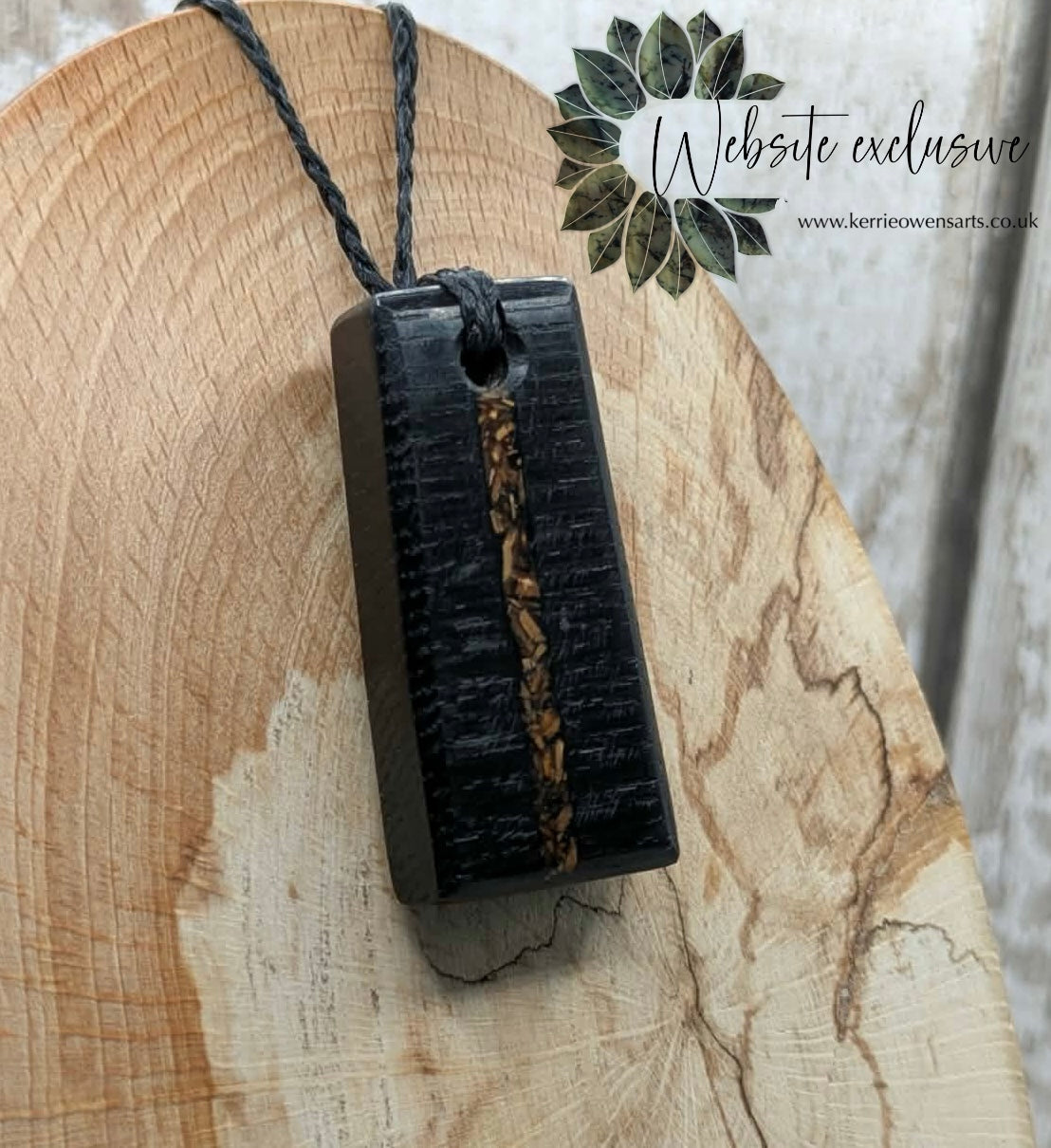 Fenland bog oak rectangular pendant with mammoth tooth inlay.