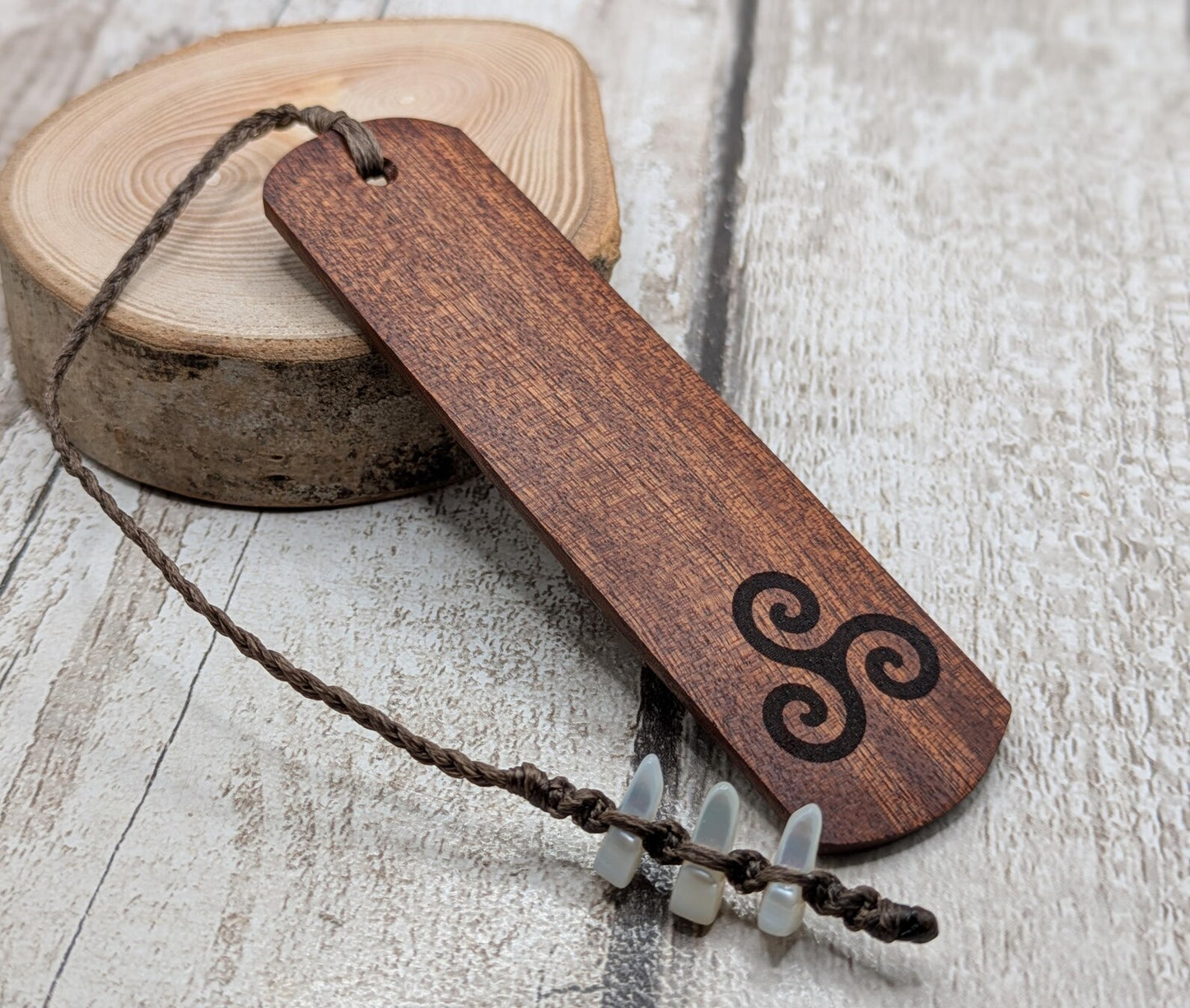 Walnut wood hand made bookmark with triskele laser print.