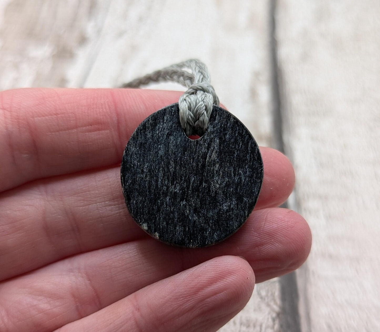 Low grade Shungite disc pendant, hight mica content.