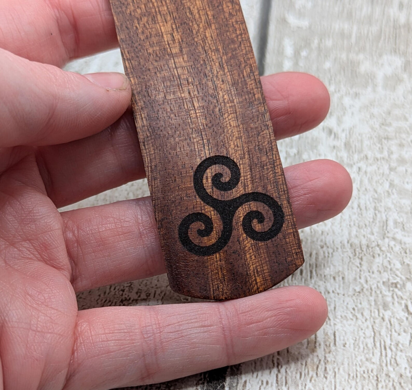Walnut wood hand made bookmark with triskele laser print.
