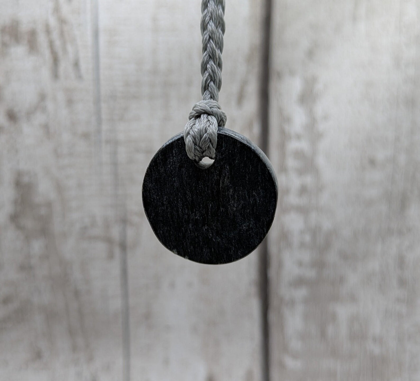Low grade Shungite disc pendant, hight mica content.