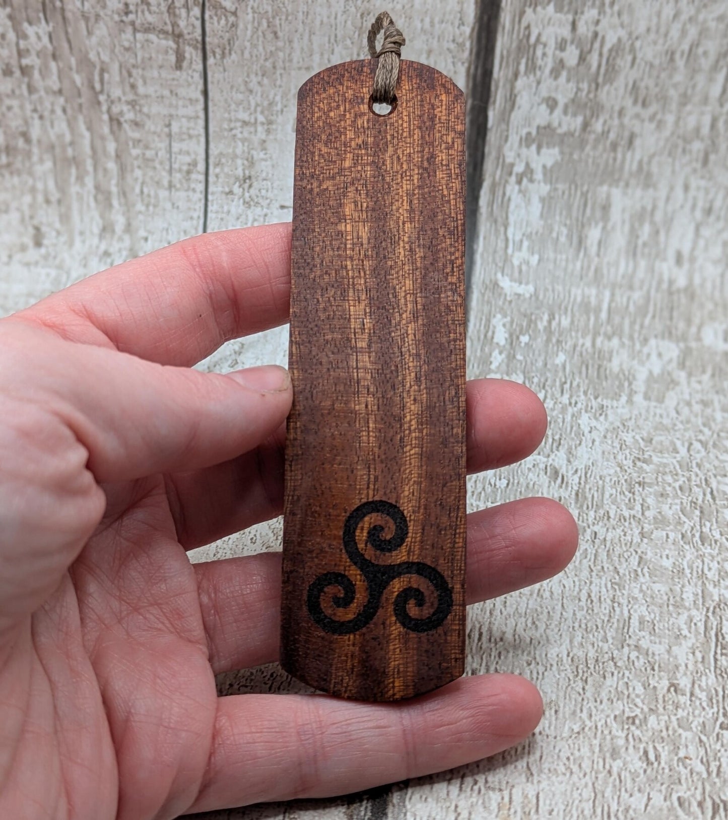Walnut wood hand made bookmark with triskele laser print.