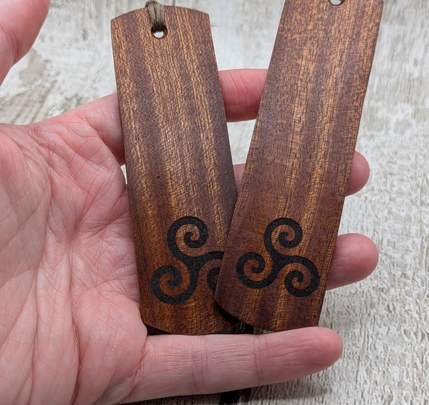 Walnut wood hand made bookmark with triskele laser print.