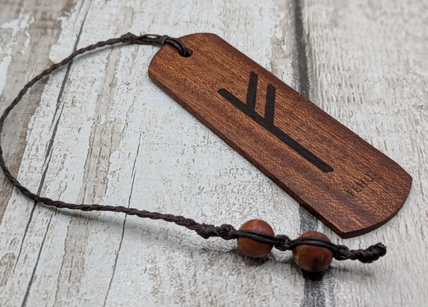 Walnut wood handmade bookmark with fehu Norse rune laser print.