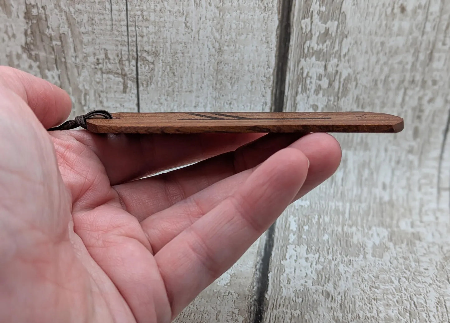 Walnut wood handmade bookmark with fehu Norse rune laser print.