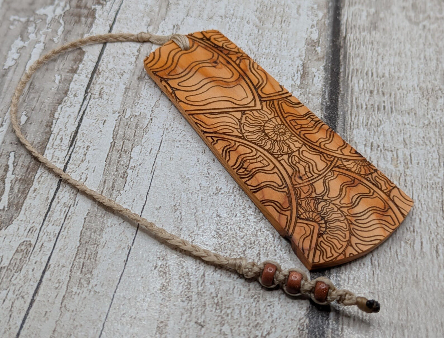 Yew wood handmade bookmark with ammonite laser print image.