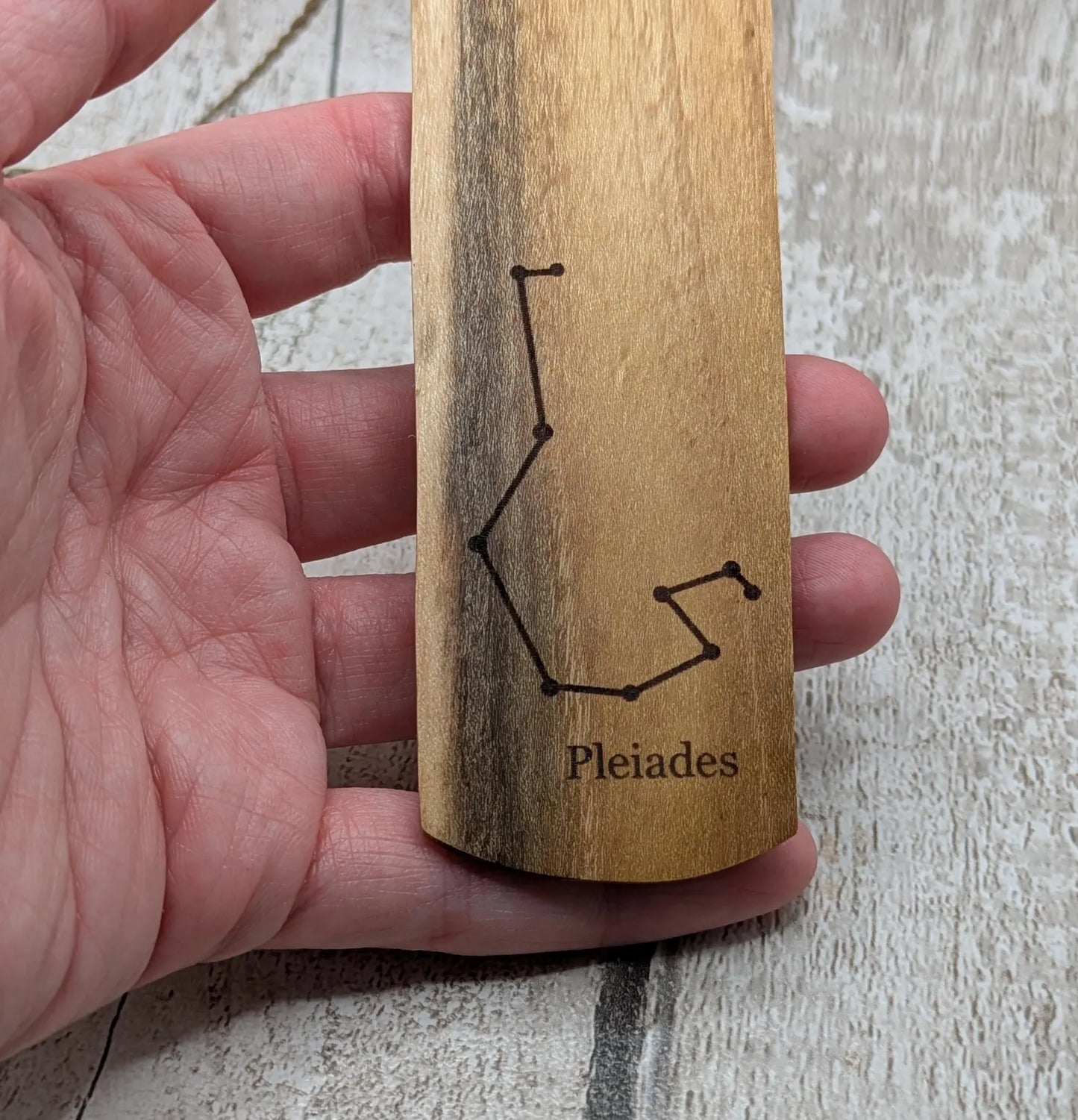 Laburnum wood hand made bookmark with Pleiades constellation laser print.