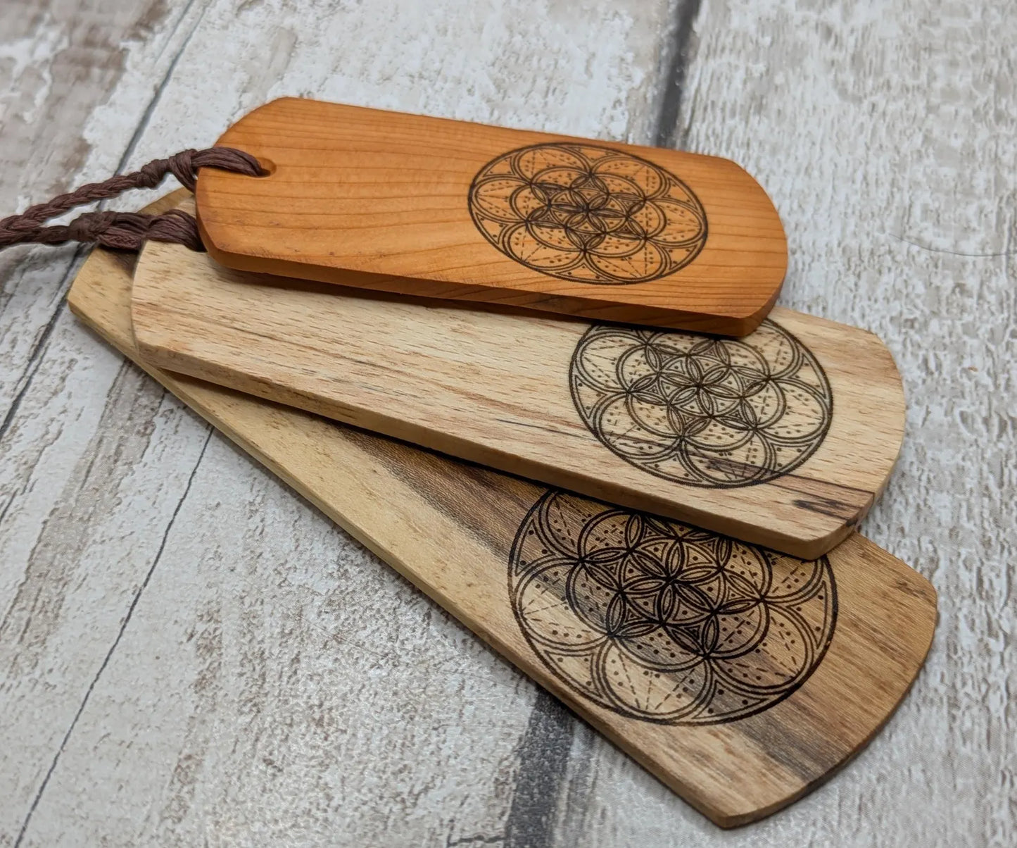 Laburnum wood hand made bookmark with geometric laser pattern.