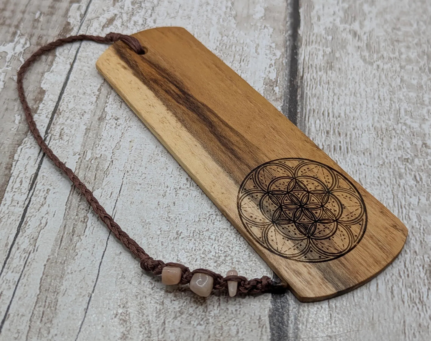 Laburnum wood hand made bookmark with geometric laser pattern.