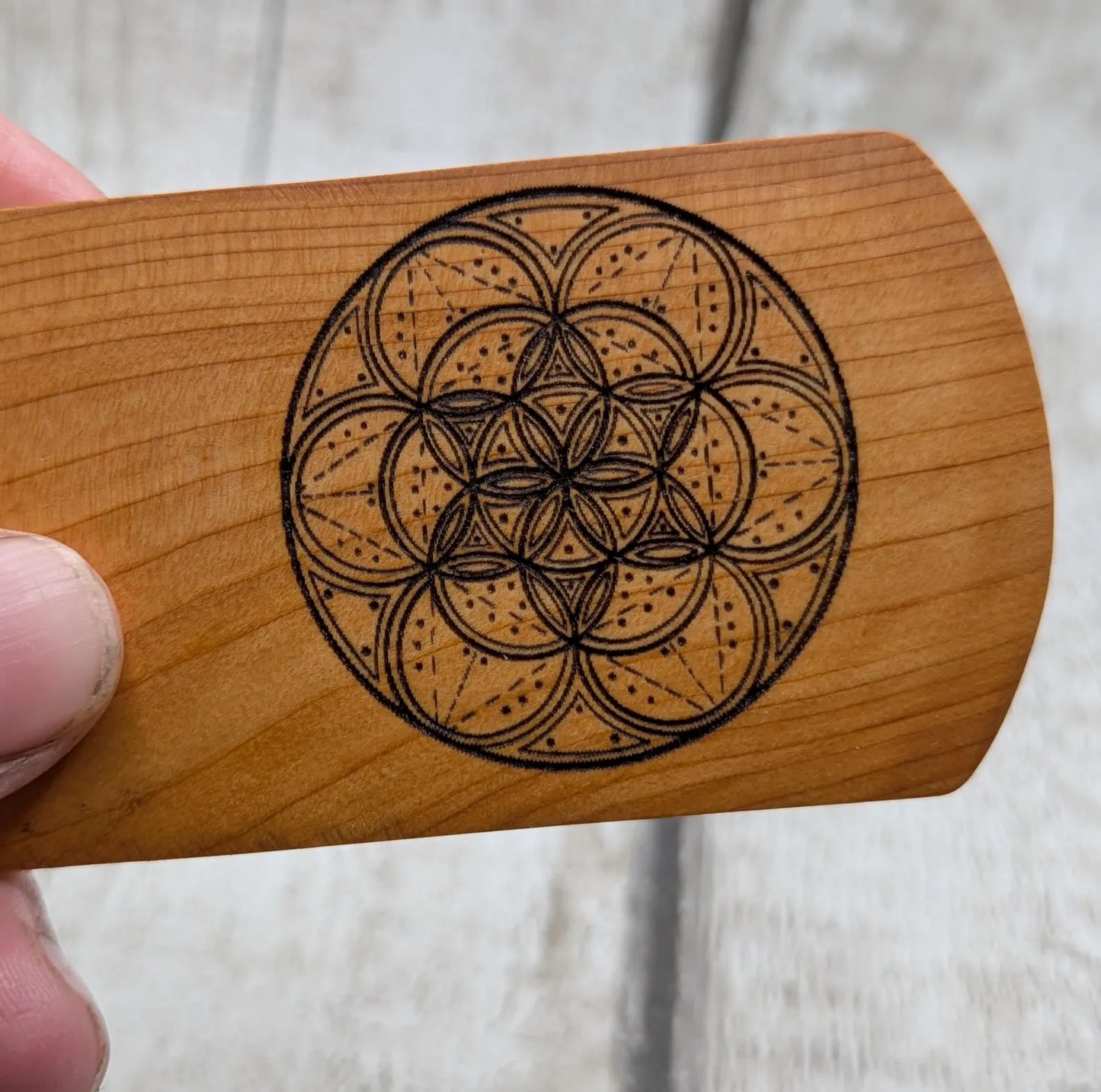 Yew wood handmade bookmark with geometric laser print.