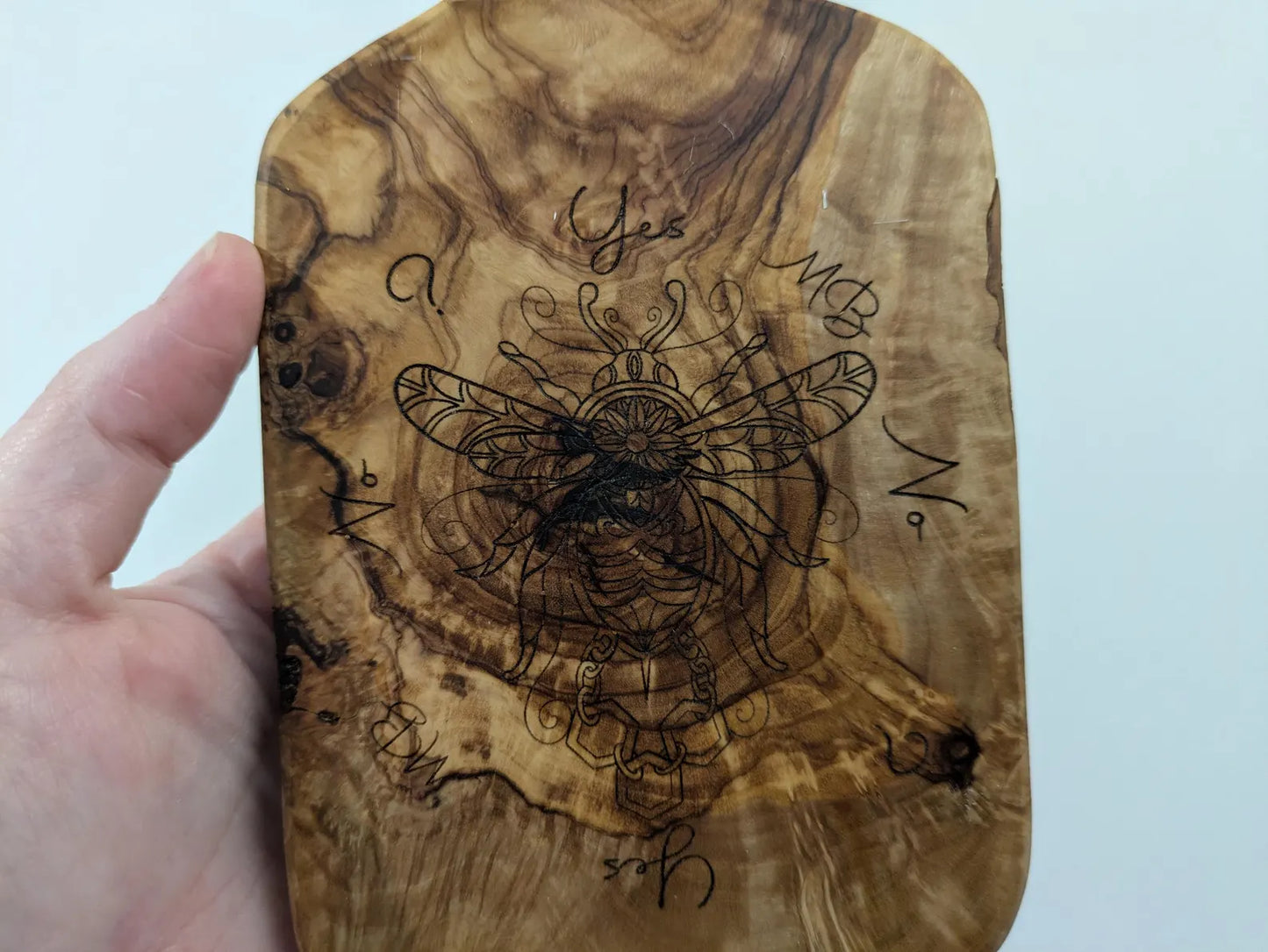 Olive wood bumble bee pendulum dowsing board with incense stick holder.