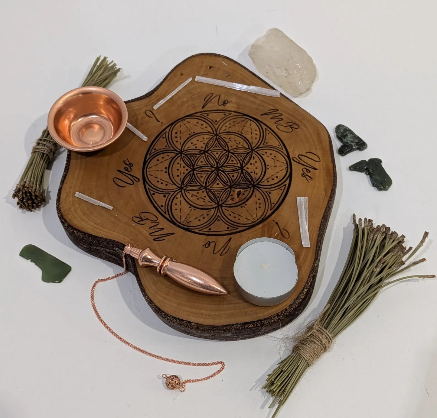 Random wood slice pendulum dowsing board with geometric laser print.