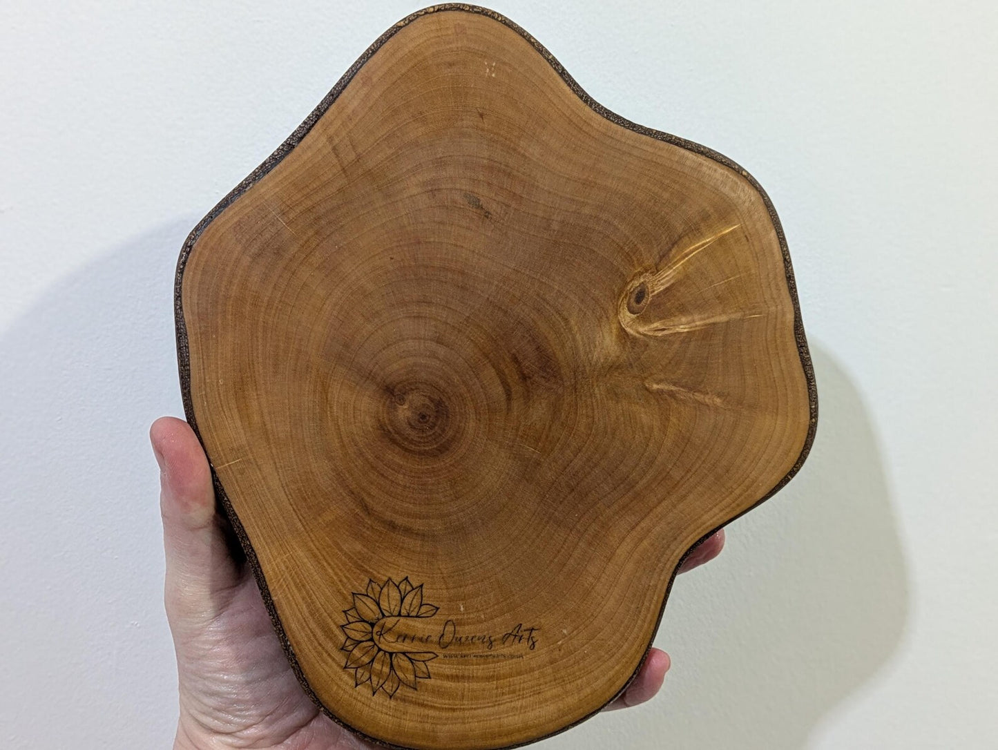 Random wood slice pendulum dowsing board with geometric laser print.