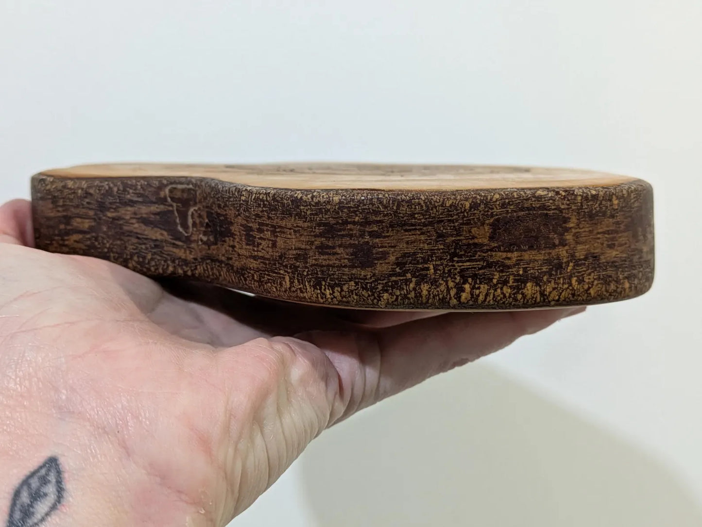 Random wood slice pendulum dowsing board with geometric laser print.