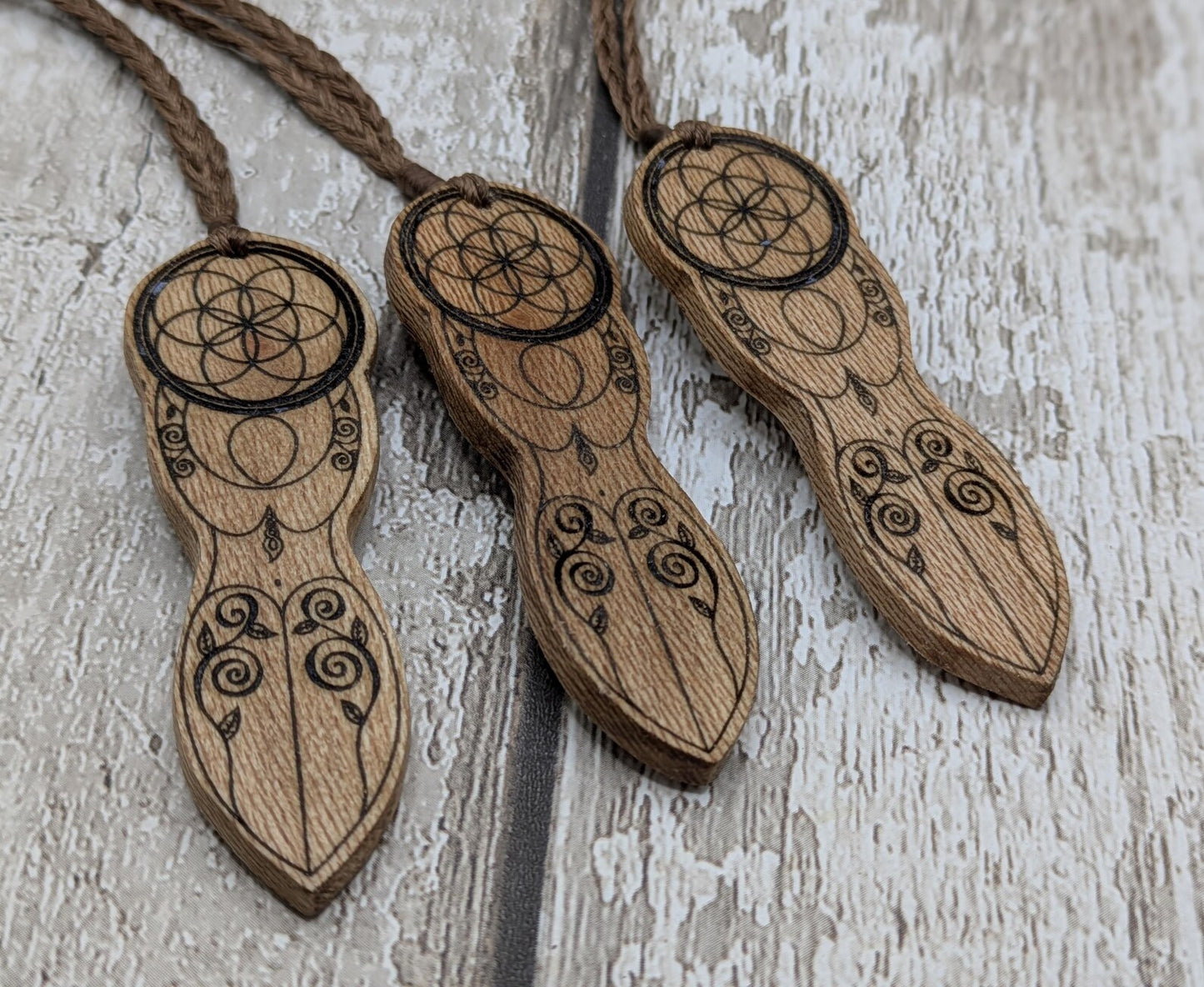 Recycled Lace wood, deity goddess 2d pendant holding the seed of life globe.