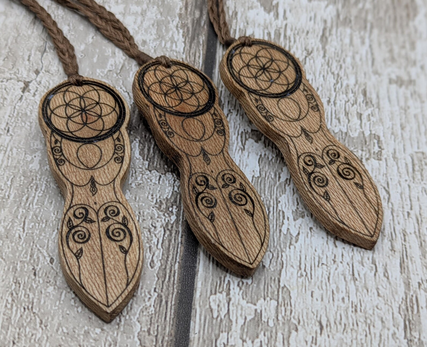 Recycled Lace wood, deity goddess 2d pendant holding the seed of life globe.