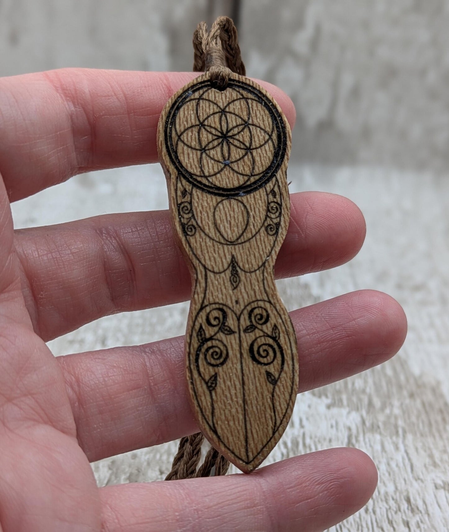 Recycled Lace wood, deity goddess 2d pendant holding the seed of life globe.