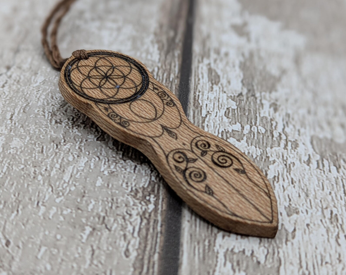 Recycled Lace wood, deity goddess 2d pendant holding the seed of life globe.