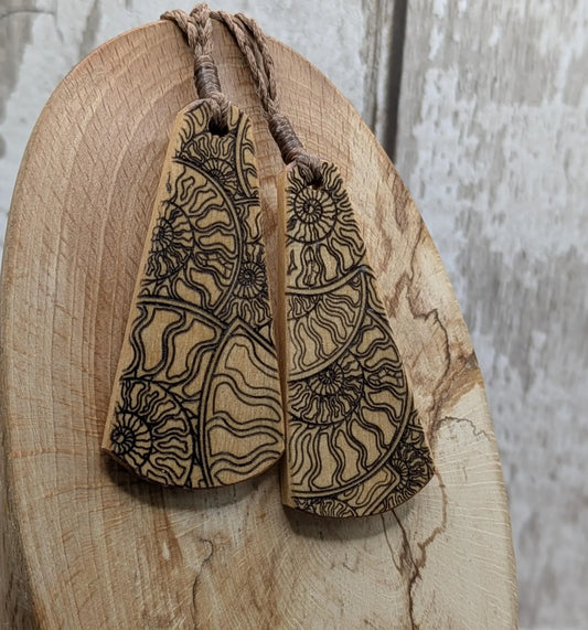 Wooden roimata pendant with laser print layered ammonite design.