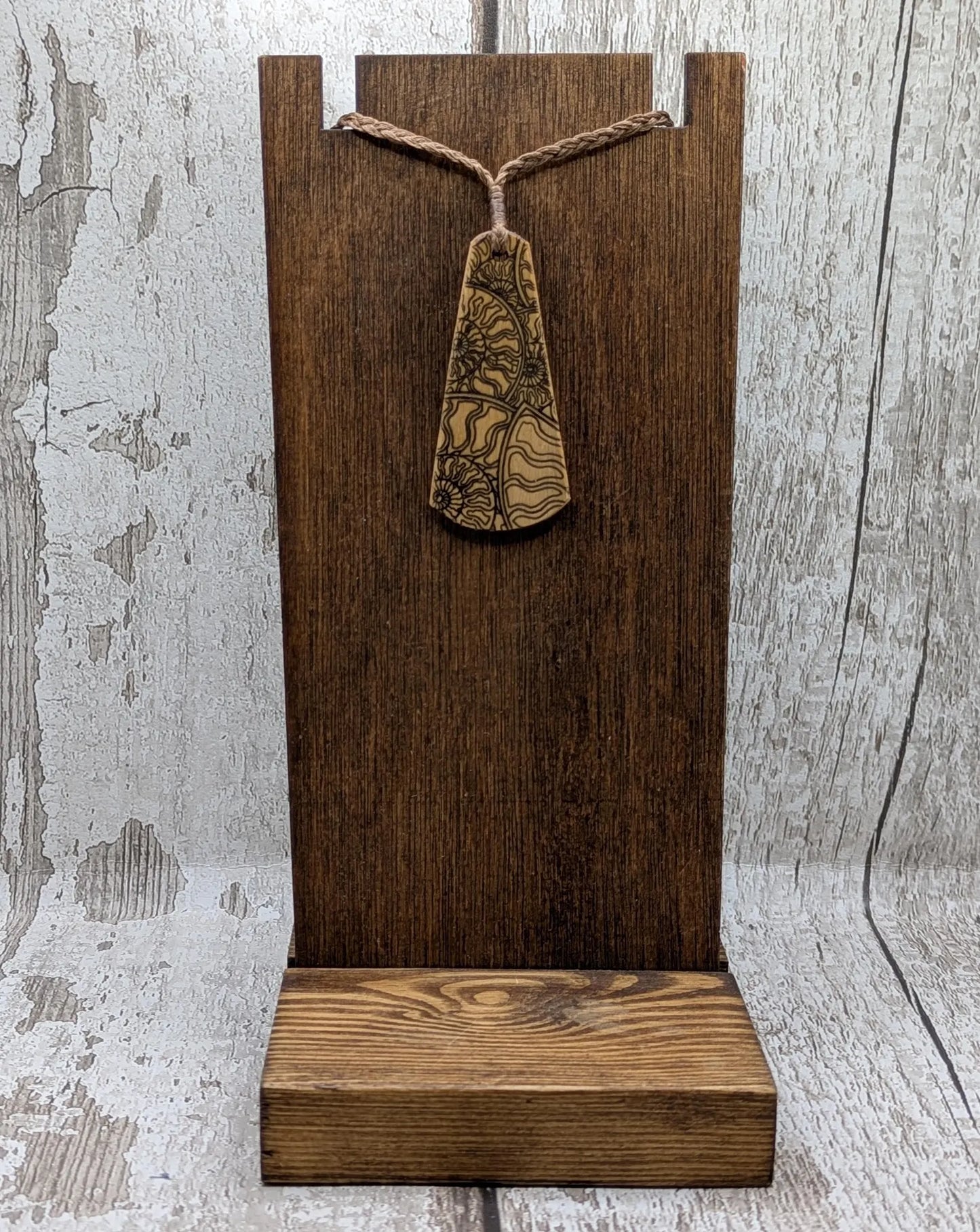 Wooden roimata pendant with laser print layered ammonite design.