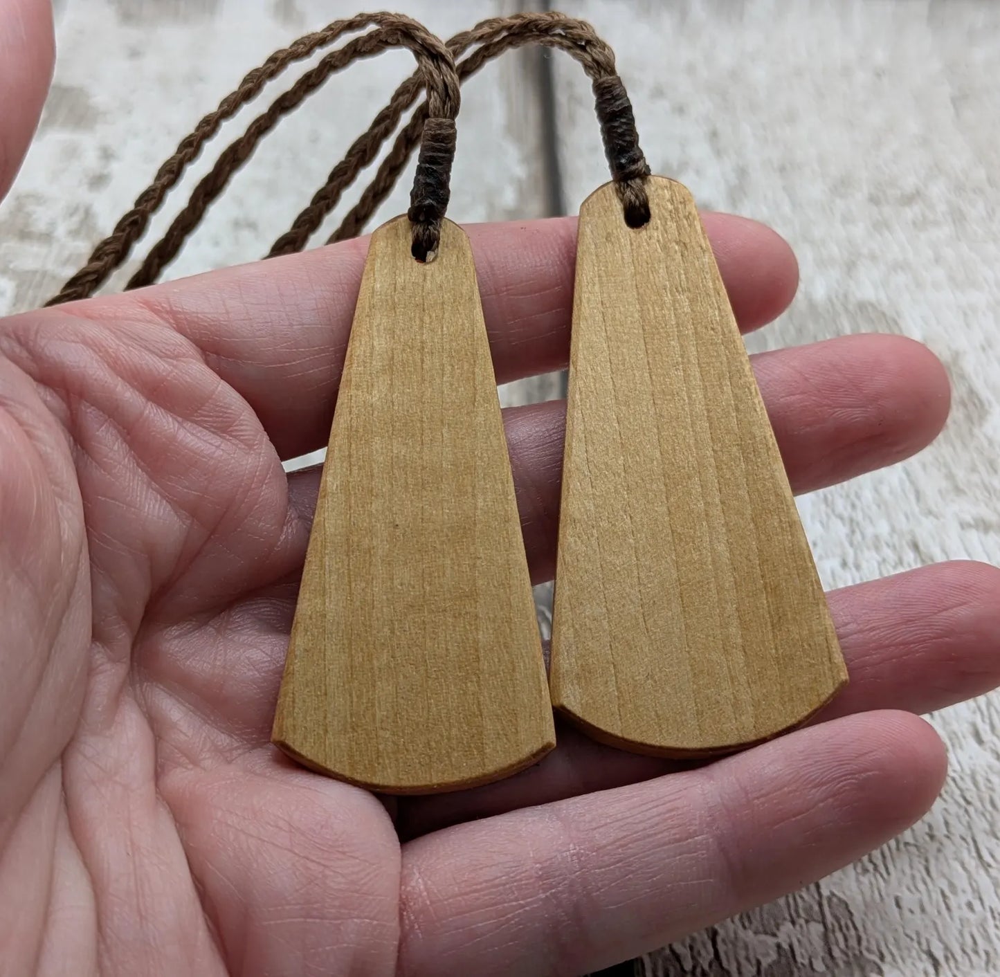 Wooden roimata pendant with laser print layered ammonite design.