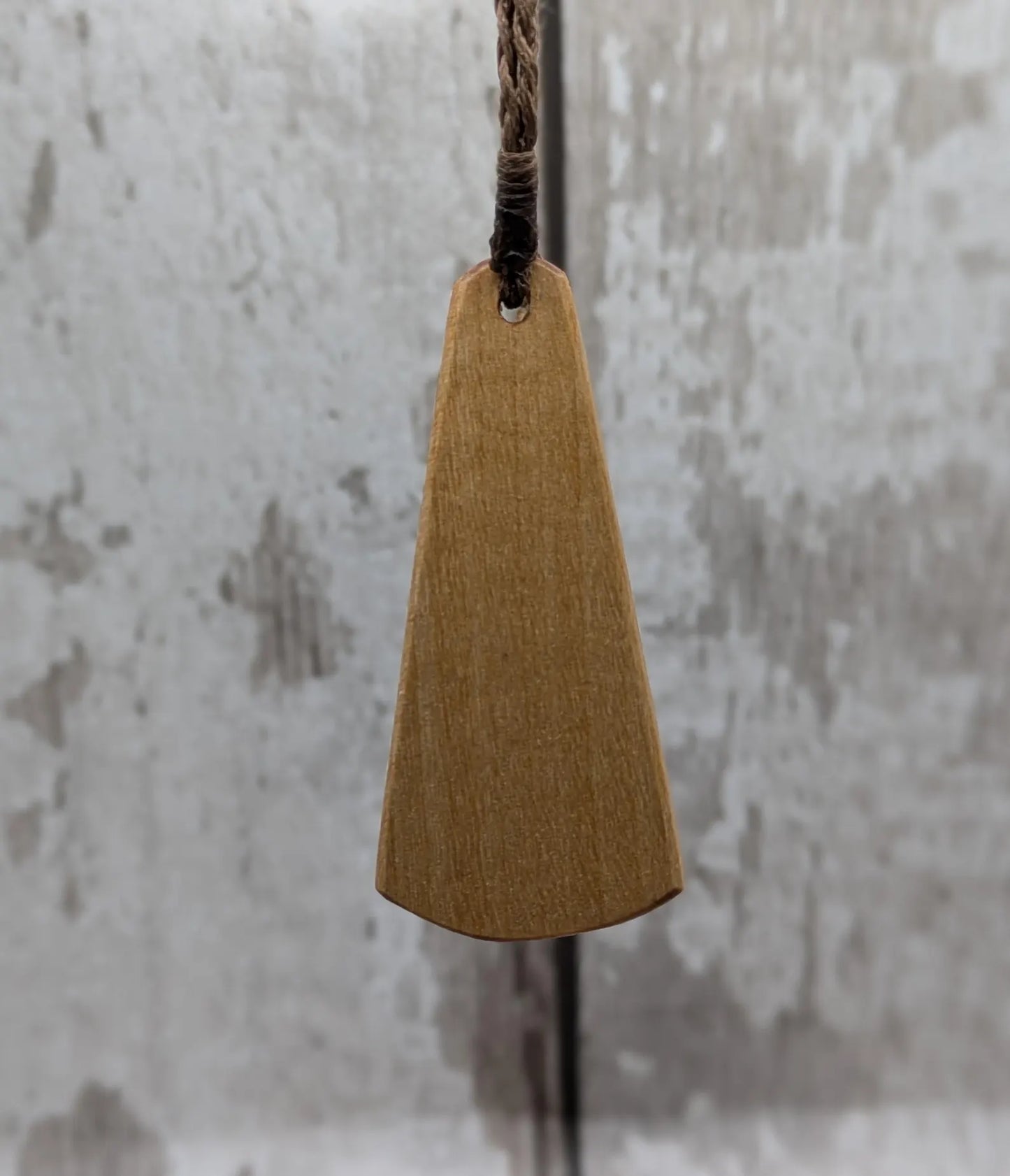 Wooden roimata pendant with laser print layered ammonite design.