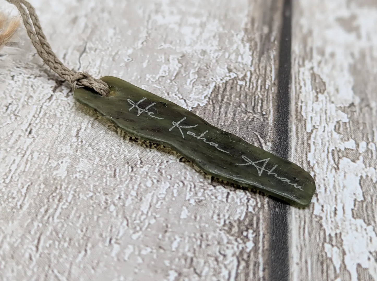 New Zealand tumbled Pounamu greenstone with I am strong in te Reo Māori affirmation.