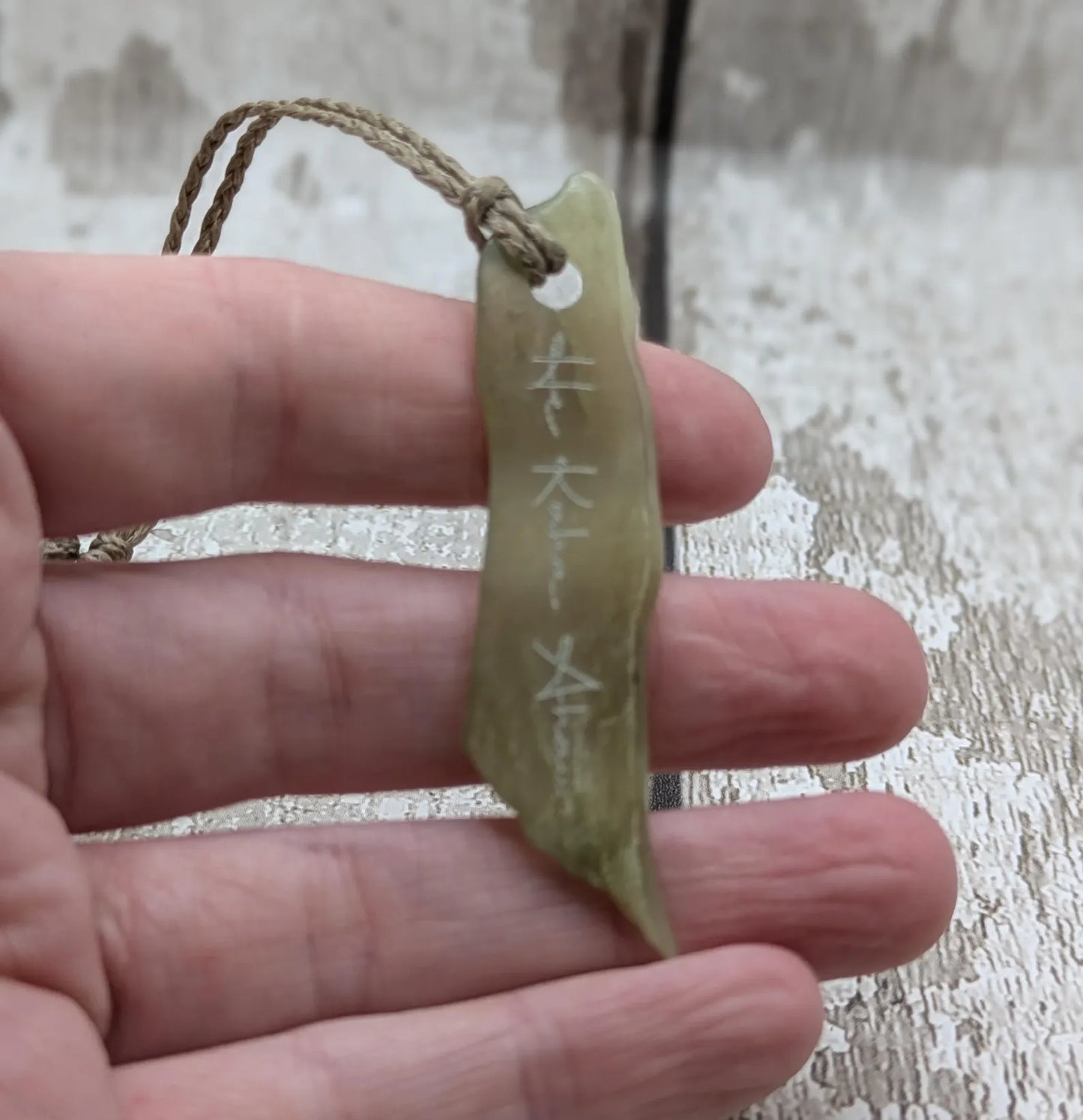 New Zealand tumbled Pounamu greenstone pendant with I am strong in te Reo Māori.