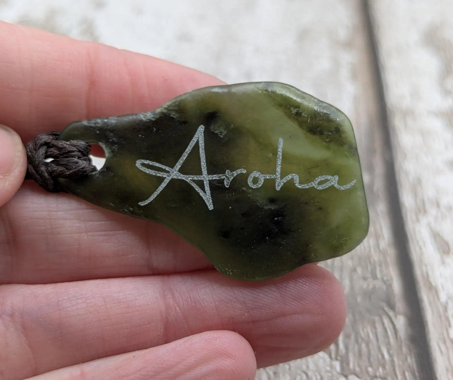 Nz tumbled Pounamu greenstone pendant with Aroha love affirmation.